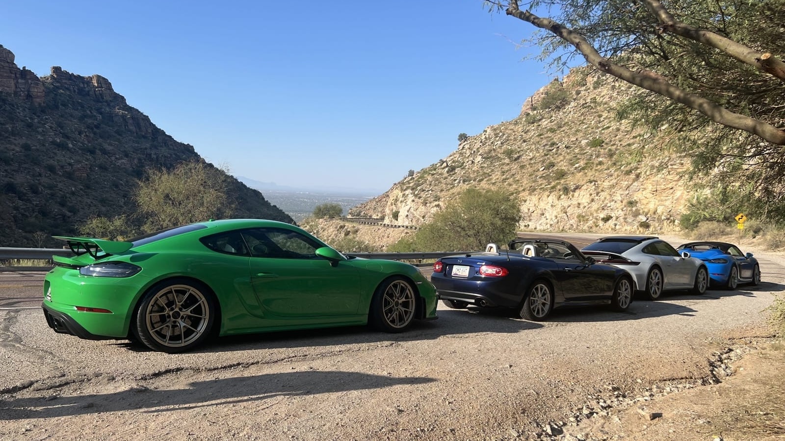 Sports cars lined up in the mountains